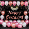 Girls car boot birthday decoration with pink, white and rose gold balloons, rose gold Happy Birthday banner and open SUV trunk setup.