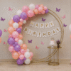 Pastel pink and white birthday balloon decoration with Happy Birthday banner and balloon arch backdrop