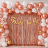 Bride to be rose gold and white balloon decoration with rose gold foil curtain, gold banner, confetti balloons and gold star foil balloons for bridal shower party.