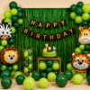Jungle safari theme happy birthday decoration with green balloons, animal foil balloons, fringe curtain and birthday banner for kids party setup.
