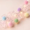 pink-pom-pom-led-light-closeup Pastel Pom Pom LED String Light with Pink Mesh – Warm White Fairy Lights for Home & Room Décor