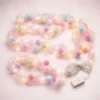 Pastel Pom Pom LED String Light Pastel pom pom LED string light with pink glitter mesh and warm white lights